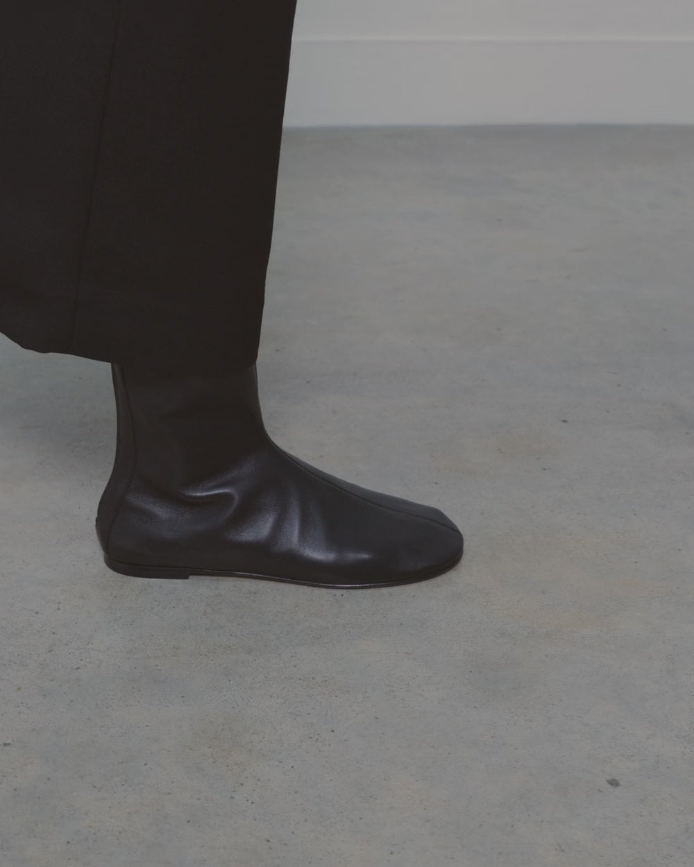 Balla Bootie in black leather, worn and walking